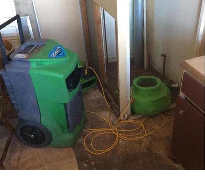 water damaged kitchen with SERVPRO dehumidifiers 
